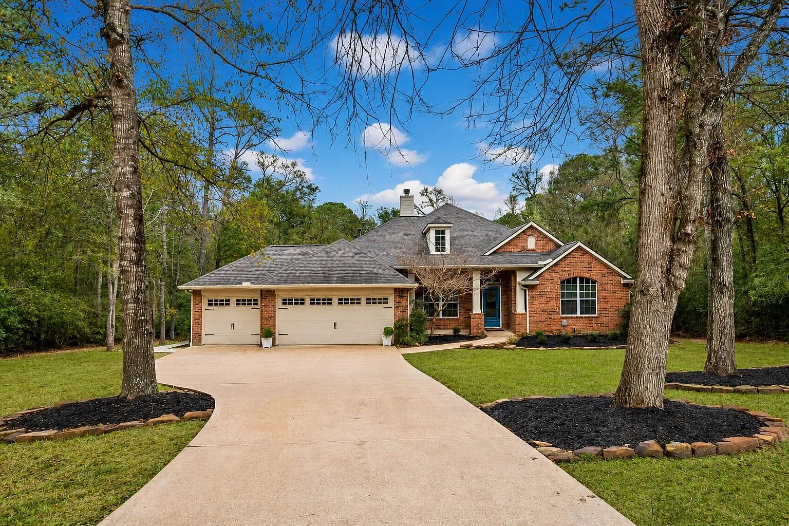 Brick home and private driveway at 27103 Bridleway Cir Magnolia TX