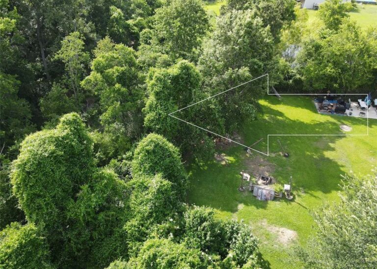 Aerial listing photograph pointing to the wooded lot at 0 Laurelwood Drive in Channelview, Texas