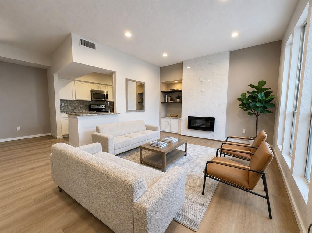 Living area with fireplace and kitchen at 1881 Bering Drive Unit 58, Houston