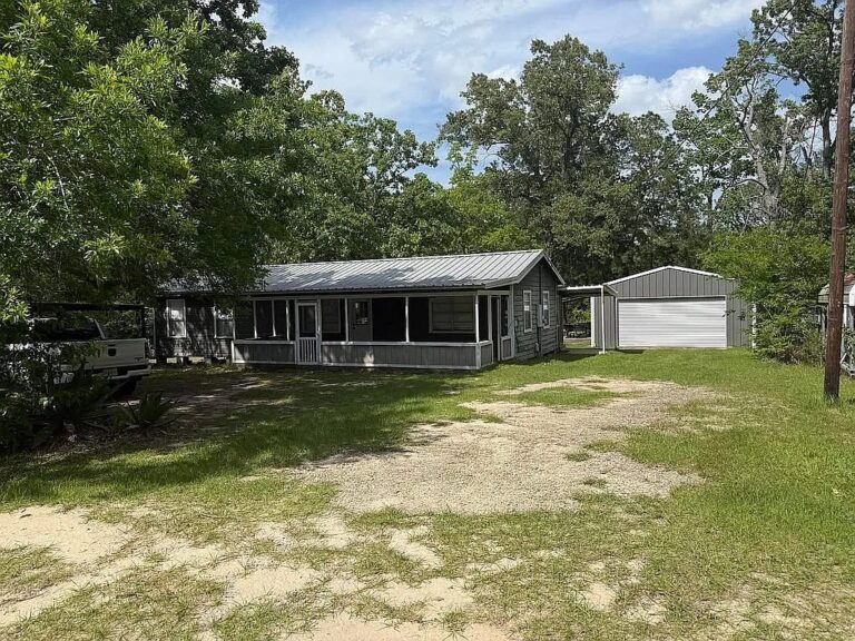 House, screened porch and detached garage at 237 Havard Street in Zavalla, Texas