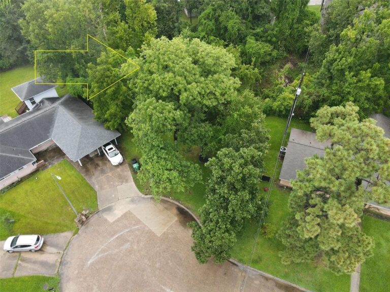 Aerial listing photograph of 9307 Ribbonwood Street in Houston, with an illustrative arrow and neighboring homes