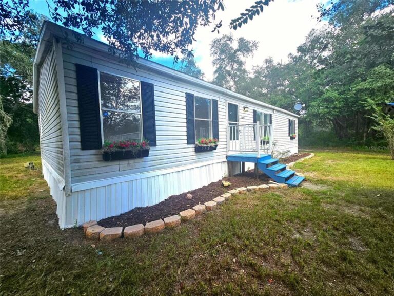 Front exterior and blue entry steps at 9485 Rousseau Street in Webster, Florida